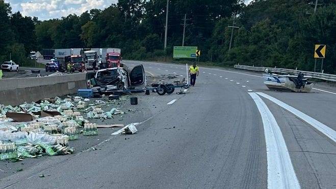 Bottles, boat left on road in multi