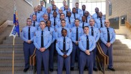 Georgia Gov. Brian Kemp swears in his daughter as a state trooper