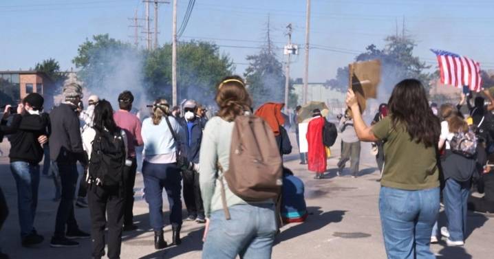 Federal agents fire chemicals as protesters try to block car at immigration site outside Chicago