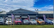 Vehicle dealership acquired by management buyout