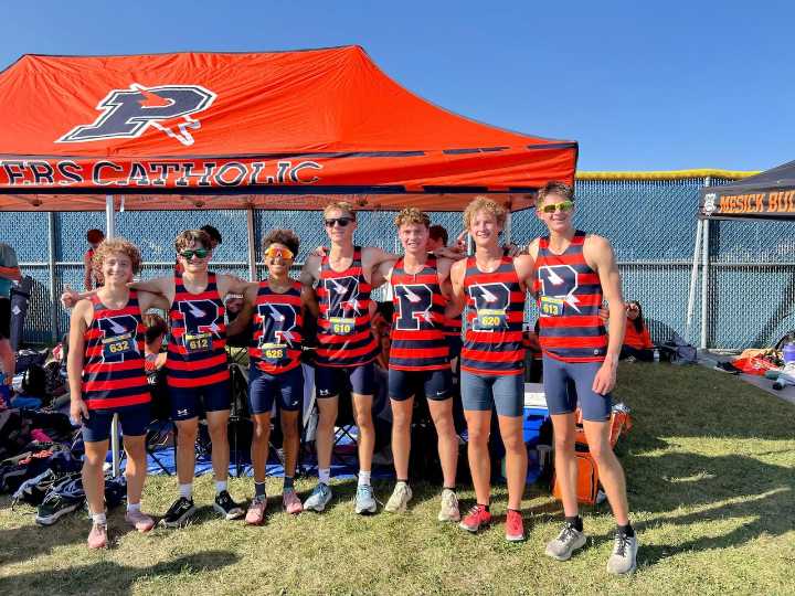 Why Powers Catholic boys cross country head coach Dave Wolbert is smiling more than usual