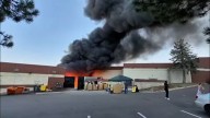 Black smoke, flames seen as fire breaks out behind Littleton thrift store