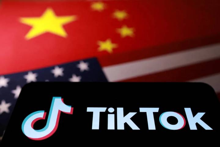 The TikTok logo is placed on U.S. and Chinese flags in this illustration taken Wednesday. U.S. President Donald Trump says he will sign an executive order related to a new TikTok agreement Thursday.