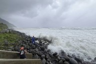 Super typhoon blowing by northern Philippines and Taiwan forces evacuations and closures