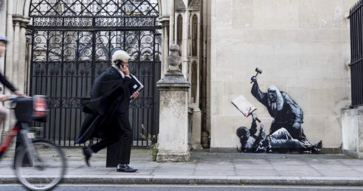 Banksy artwork showing judge beating protester appears on London, U.K. court wall