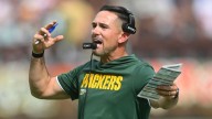 Amid the chaos during NFL games, coaches aim to maintain calm inside the headset