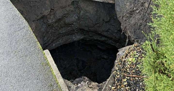 Couple who live next to giant sinkhole that appeared over weekend 'have suitcases packed'