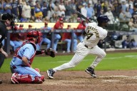 Playoff-bound Brewers rally from 5 runs down to beat skidding Cardinals 9