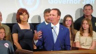 Louisiana governor pays fine and discloses $13K in unreported free trips in deal to end ethics probe