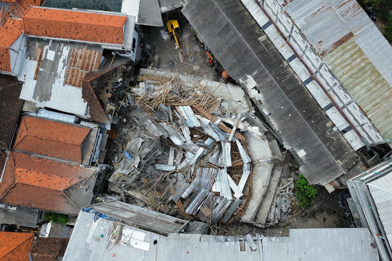 Rescuers run oxygen to survivors in Indonesia school building collapse that buried dozens