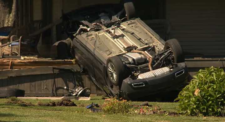 Rollover crash leaves car upside down on McDonald porch