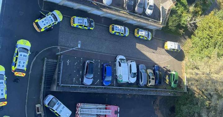 Man charged with attempted murder after police swarm flat as woman rushed to hospital
