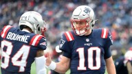 Kendrick Bourne leaning on QB Mac Jones during 49ers return
