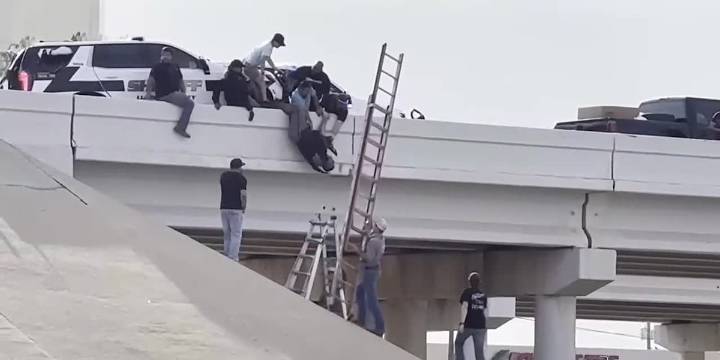2 deputies seriously injured in crash that left one of them dangling from overpass