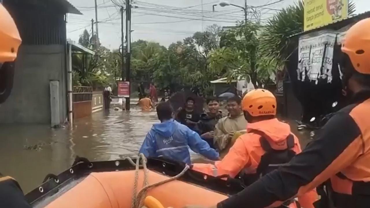 Flash floods in Indonesia leave at least 15 dead and 10 missing