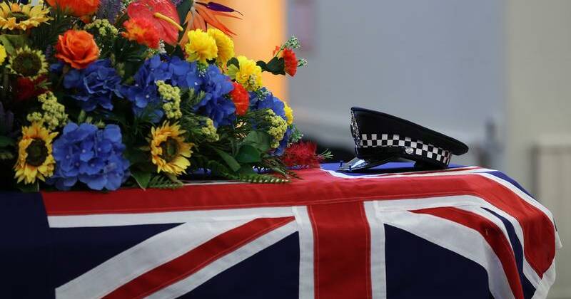 Sea of blue circles officer's coffin as funeral begins