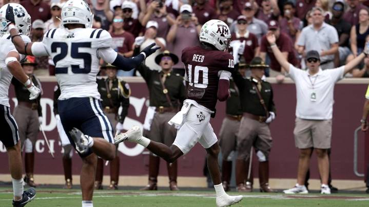 Reed leads Texas A&M past Utah State with 4 TDs