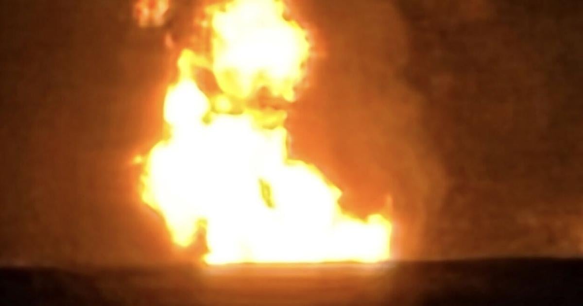 Authorities investigate train fire involving a ruptured gas pipeline