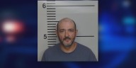 Man arrested for firing multiple shots through apartment floor