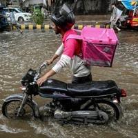 No pause for food delivery riders during Pakistan's monsoon