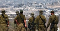 Thousands of Israeli reservists report for duty, as military chief clashes with ministers
