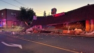 Person dies after car crashes into sports bar causing partial roof collapse
