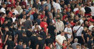 Riot police stream into stadium as England game paused after warnings of violence