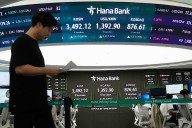 Asian shares trade mixed after US stocks set more records