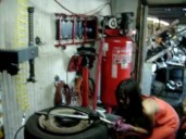 Asian Lady Who Changes Tires In A Dress