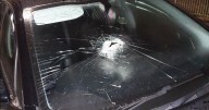 Hooded man smashes a dozen car windscreens in random act of violence