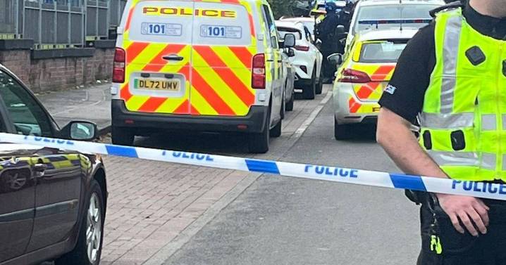 Armed police swarm Glasgow street as man hospitalised and two people arrested