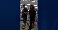 Woman uses hand signal to report suspected abuser