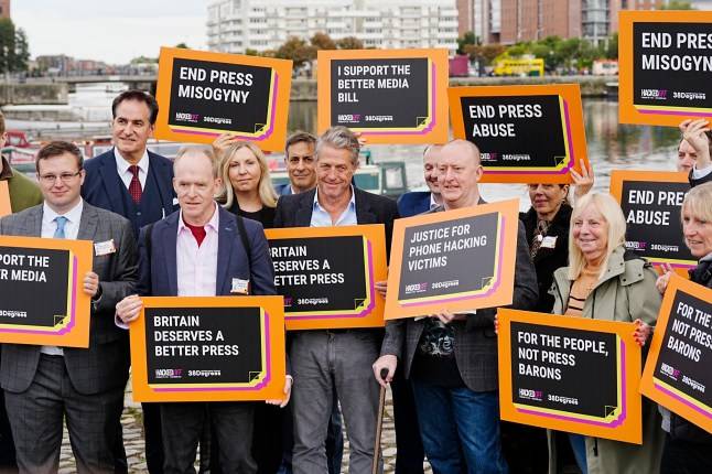 Hugh Grant proudly holds sign with campaigners outside Labour Party conference