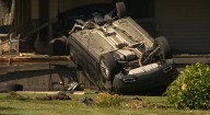 Rollover crash leaves car upside down on McDonald porch