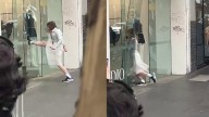 Shock footage captures brazen broad daylight theft as woman breaks through door of clothing store in front of stunned onlookers