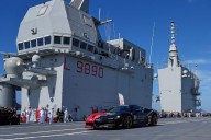 Man in Italian supercar chases world record atop aircraft carrier