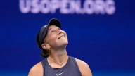 Anisimova struggles to serve with Arthur Ashe Stadium's roof closed during the US Open final
