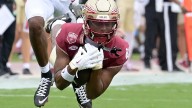 Florida State WR Squirrel White trampled by fans during Virginia field rush, sparking concerns