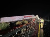 Semi-truck tips over after heavy rain brings dangerous road conditions