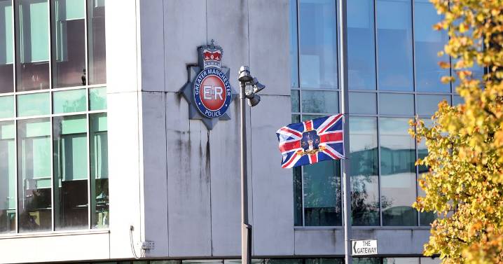 Union flags flying from lampposts around Greater Manchester Police HQ