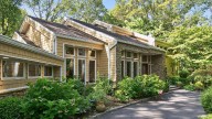 This $2.2M Melville house comes with ponds of koi and goldfish