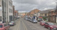 Driver arrested after crash closes busy road and tramline