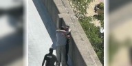 Officer walks man back from edge