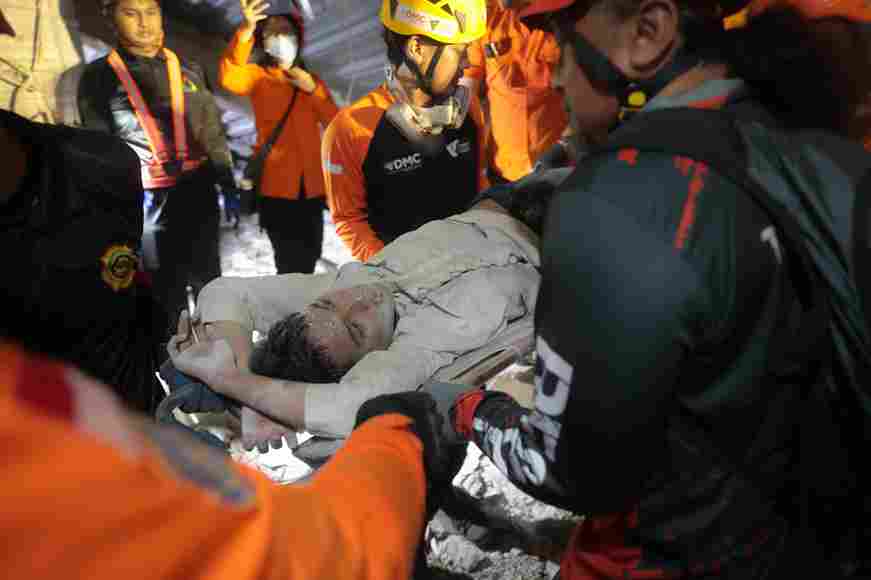 65 buried in Indonesia school building collapse; rescuers run oxygen to survivors
