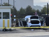 Man flees after ramming car into FBI building, throws American flag over gate