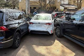 Suspended, but man drives into two police cars