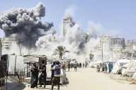 Israel targets more buildings in Gaza City and warns residents to flee