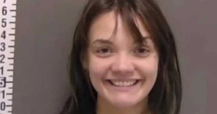 US Woman grins in mugshot after 'trying to kill sleeping boyfriend with hatchet'