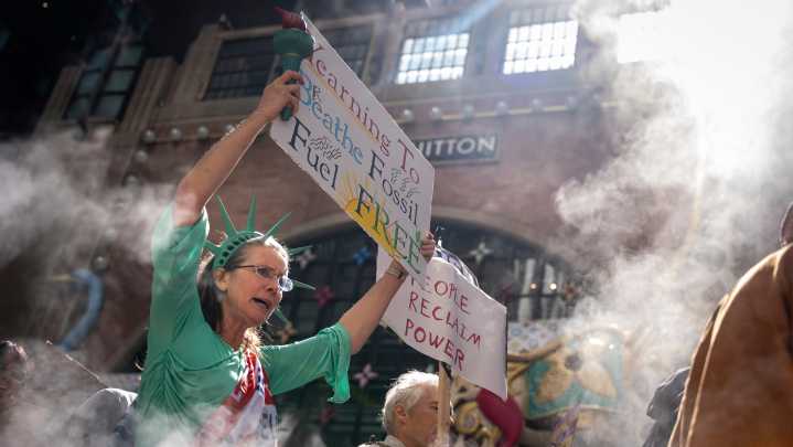Marchers gather in protest of financial institutions 'profiting off the climate crisis'