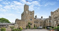 Castle with moat near pretty market town has wing for sale
